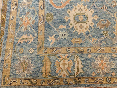 Corner of a blue & green Kars Turkish area rug.