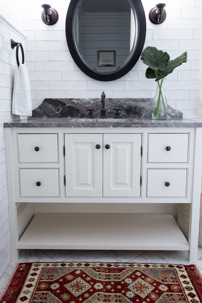 Red & orange extra small Turkish Yastik Rug in a modern bathroom.