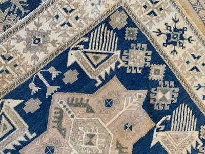 Close up on custom corner imagery on a blue & green large sivas Turkish Rug.