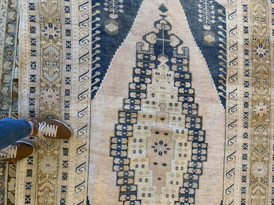 Woman's feet on a blue & green medium Sivas Turkish Rug.