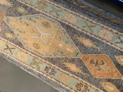 Central medallion on a blue & green Turkish runner rug.