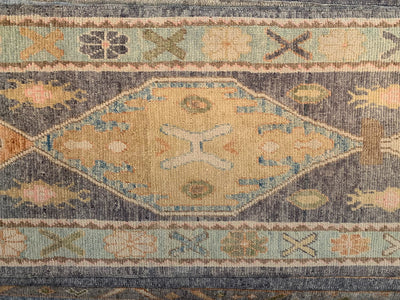 Central medallion on a blue & green Turkish runner rug.