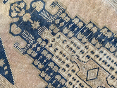Close up on large central medallion on ablue & green Sivas Turkish Rug runner.