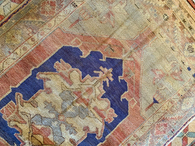 Central medallion on a vintage small blue & green Cal Turkish rug.