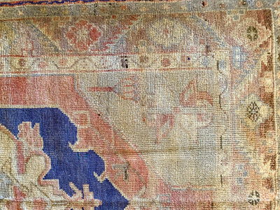 Close up of hand knotting on a small blue & green Cal Turkish rug.