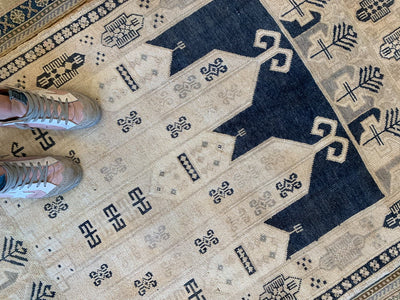 Woman feet on a blue & green small Sivas Turkish Rug.