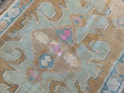 Central medallion with pink features on a blue & green small Sivas Turkish Rug.