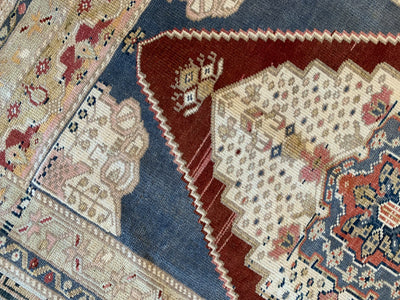 Corner work on other side of a blue & green small Sivas Turkish Rug.