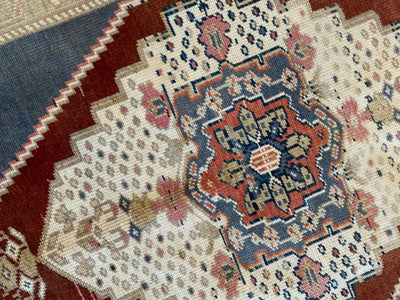 Central medallion on a blue & green small Sivas Turkish Rug.