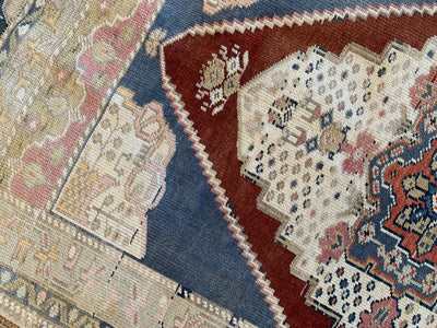 Corner work on a blue & green small Sivas Turkish Rug.