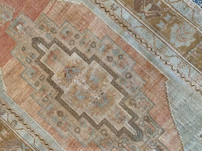 Central medallion on a brown & grey medium Sivas Turkish Rug.