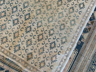 Corner of a brown & grey small Sivas Turkish Rug.