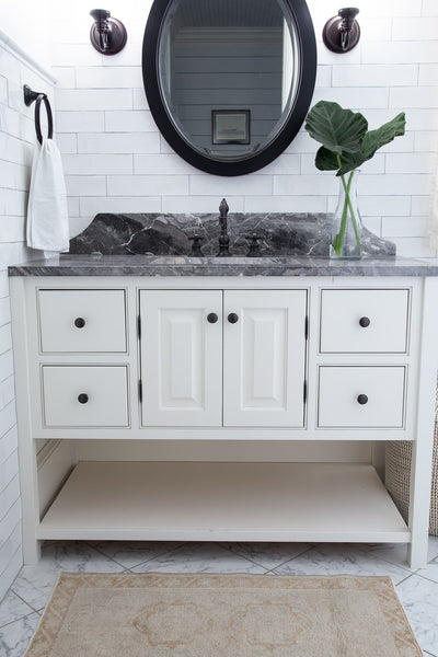 A brown & grey extra small Turkish Yastik Rug in a modern bathroom