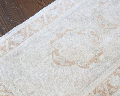 Washed out central medallion of a brown & grey extra small Turkish Yastik Rug.