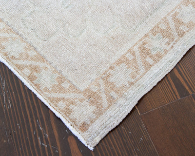 Corner of a brown & grey extra small Turkish Yastik Rug.