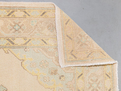 Folded corner of a large brown & grey Bor Runner Turkish rug.