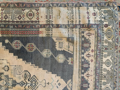 Corner of a large brown & grey Sivas Turkish Rug.