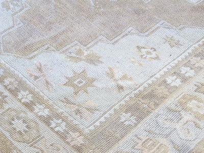 Knotting close up of a brown & grey medium sized Maden Turkish rug.