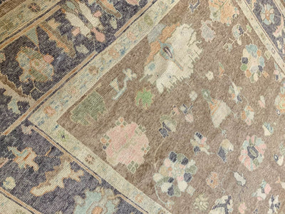 A brown & grey Oushak Turkish area rug.