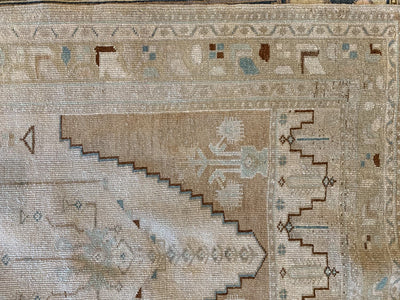 Corner of a brown & grey small Sivas Turkish Rug.