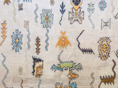 Close up of an extra large brown & grey Turkish Oushak rug.