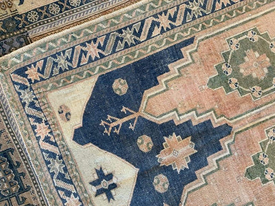 Corner shot of medium sized blue green Sivas Turkish Rug.