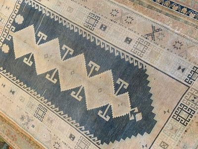 Top down shot of a brown & grey Sivas Turkish rug.