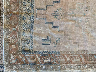 Corner symbols on a medium brown and grey Sivas Turkish rug.