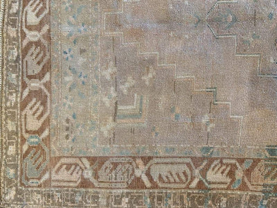 Corner of medium brown and grey Sivas Turkish rug.