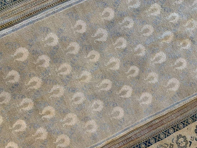 Top down shot of a medium brown and grey Sivas Turkish rug.
