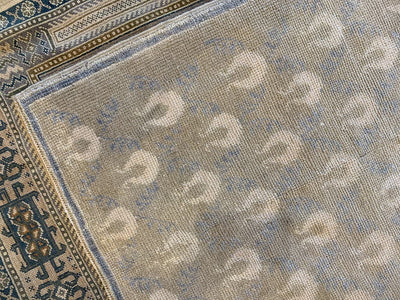 Corner shot of patterned medium brown and grey Sivas Turkish rug.