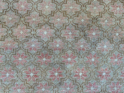 Close up medallion pattern on medium brown and grey Sivas Turkish rug.