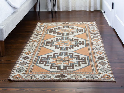 Bedroom floor with red & orange small Varosh Turkish rug.