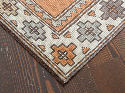 Corner of red & orange small Varosh Turkish rug.