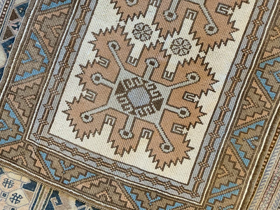 One of two large medallions on a extra small red & orange Kars Turkish Rug.