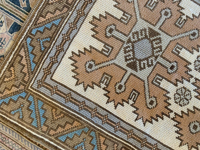 Close up on the corner of a extra small red & orange Kars Turkish Rug.