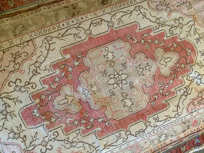 Central red medallion on a medium red & orange Guney Turkish rug.