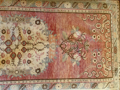 A medium red & orange Guney Turkish rug.