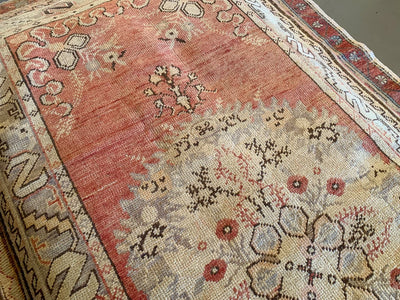 A medium red & orange Guney Turkish rug.