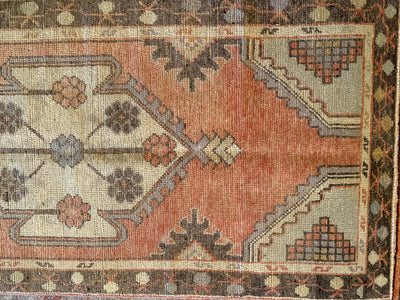 A small red & orange Cal Turkish rug.