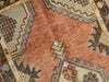 Close up on hand knotting on a small red & orange Cal Turkish rug.