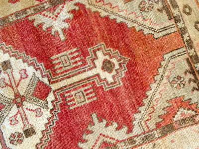 A small red & orange Cal Turkish rug.