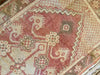 Central medallion and surrounding border on a small red & orange Cal Turkish rug.
