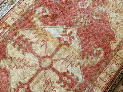 A small red & orange Cal Turkish rug.