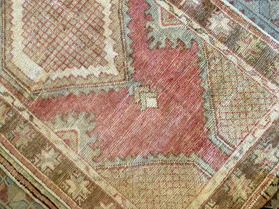 A small red & orange Cal Turkish rug.