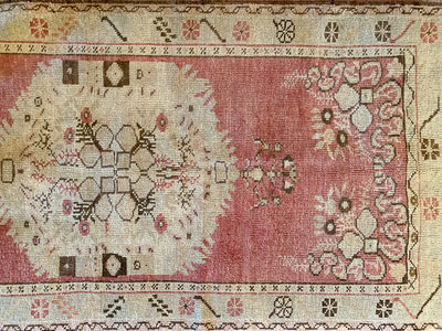 Close up of hand-knotting on a small red & orange Guney Turkish rug.