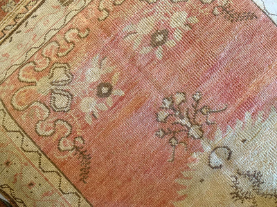 A small red & orange Guney Turkish rug.