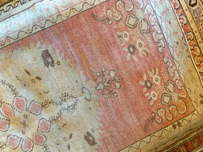 A small red & orange Guney Turkish rug.