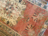 Central medallion and surrounding motifs on a small red & orange Guney Turkish rug.