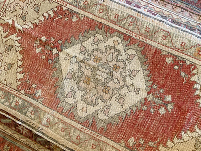 White central medallion on a small red & orange Guney Turkish rug.